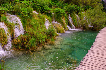 Picturesque landscapes of Plitvice Lakes with waterfalls, mountain rivers, forests and mountains