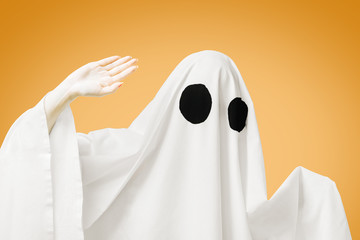 Halloween cute white ghost wave a hand.