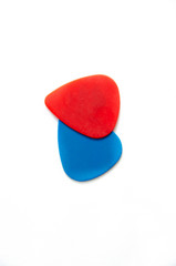 Red and blue guitar pick for guitar. Plectrum for playing stringed instruments. Macro. On white background