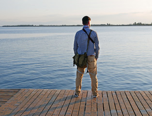 Man looking at a lake in the afternoon hours