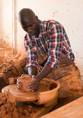 Fototapeta na wymiar Man making ceramics on pottery wheel