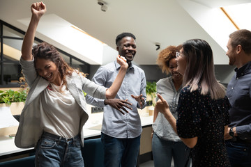 Diverse office workers celebrating financial success or career growth