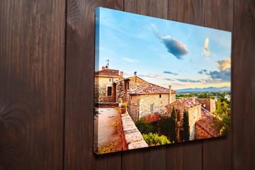 Canvas photo print on brown wooden background. Sample of gallery wrapping method of canvas...