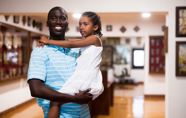Man and his little daughter visiting museum