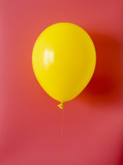 Yellow balloon on red background