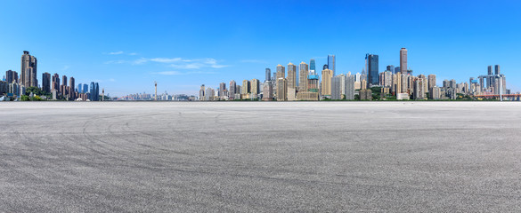 Wide race track ground and city financial district with buildings in Chongqing,China.
