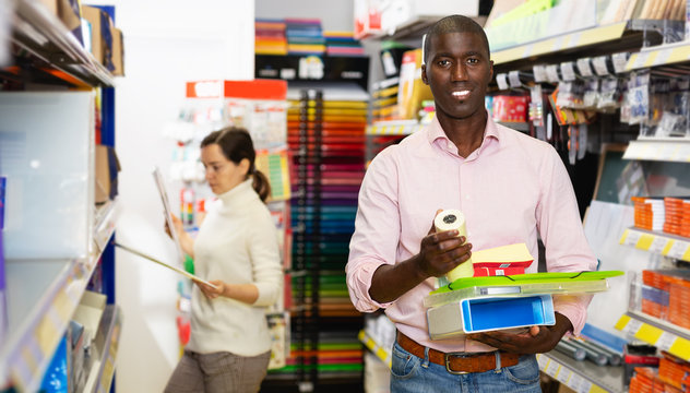 African man choosing office supplies