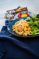 Cooked pasta with peeled shrimp, coconut milk sauce and broccoli