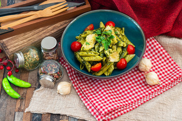 Pasta with pesto sauce and nuts on a the table