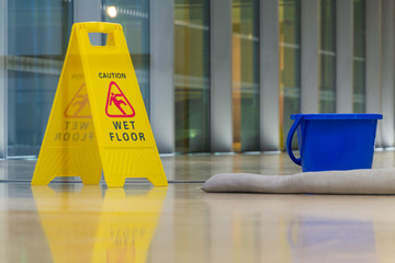 The yellow caution sign showing warning of slippery wet floor