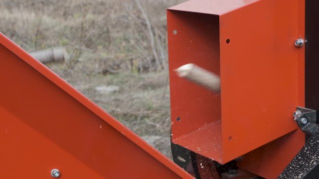 Automatic chopper chopping thick branches. Crusher branches with automatic feeding of material to freight vehicles. Slow motion.