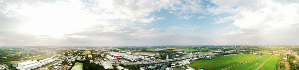 Panorama Aerial cityscape of cities, houses, roads, traffic and green areas on the outskirts of Bangkok, Thailand.