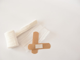 Adhesive plaster and gauze dressing. White background.