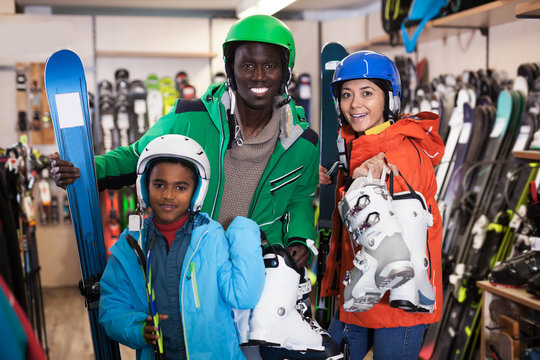 Multiracial Family Posing In Skiing Gear