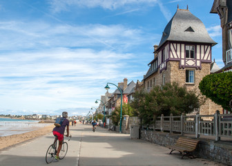 People walking along promenade at seafront in Saint Malo, Brittany, France