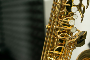 Pearly keys of a golden and shiny tenor saxophone