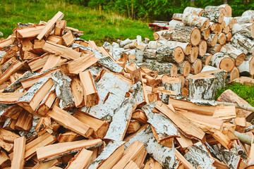 Background of a stack of split logs in a woodpile for use as domestic heating in winter with a...