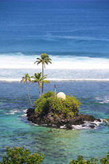 A small island in front the Seabreeze Resort Samoa. Samoa coastal aerial view.