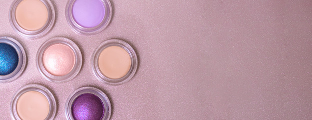 round eye shadows are arranged in the shape of a flower on a gold background with copy space