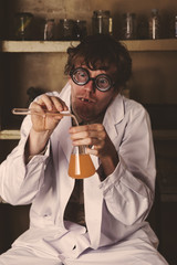 Crazy scientist mixing potions in laborator