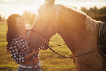 Beautiful young girl with her horse, autumn outdoors scene