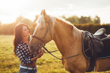 Obraz premium Beautiful young girl with her horse, autumn outdoors scene