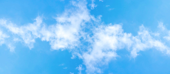 White clouds in the blue sky in the morning on a panorama background.
