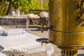 Vintage metal copper tea samovar. Crane of an old vintage samovar. The details of the samovar. Outdoor.