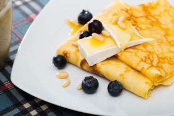 Appetizing pancakes with cheese, honey and nuts