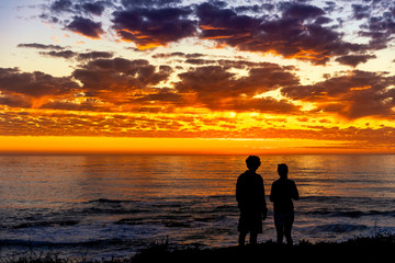 Fototapeta premium Silhouette of People at Sunset on Beach, Ocean 