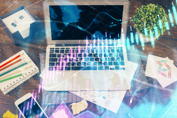 Double exposure of graph and financial info and work space with computer background. Concept of...