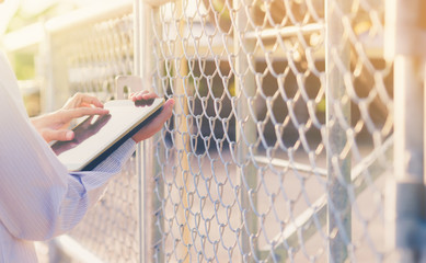 Technicians use the tablet to check the telecommunication device.