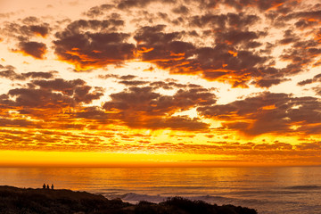 Fiery Sunset with Clouds, Ocean, Bluff, Couple Silhouette 