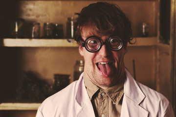Crazy scientist laughing in laboratory