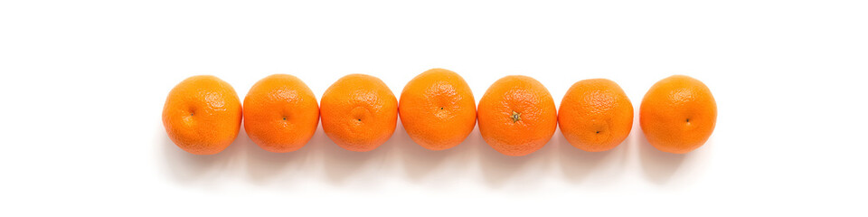 Fresh tangerines in a row on a white background, isolated, border. View from above. New year concept