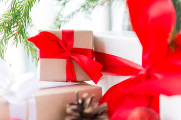 several gift boxes with red ribbon, cone, spruce branch