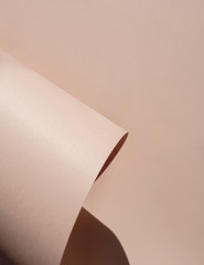 Abstract background in light pastel beige. Paper rolls. Copy space	