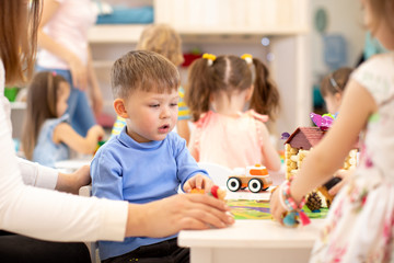 Group of kids on lesson in kindergarten or playschool