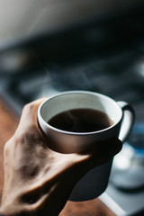 hand holding a cup of coffee