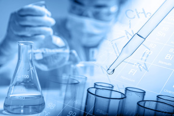 Scientist testing some chemical sample at laboratory with lab glassware on the table. Science research and development new innovation technology concept.