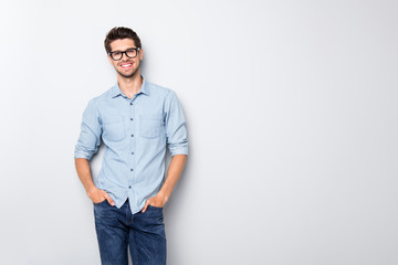 Photo of cheerful funky positive intelligent man smiling toothily holding hands in pockets isolated...