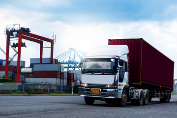 Cargo Red Container truck in ship port Logistics.Transportation industry in port business concept.import,export logistic industrial Transporting Land transport on Port transportation storge     