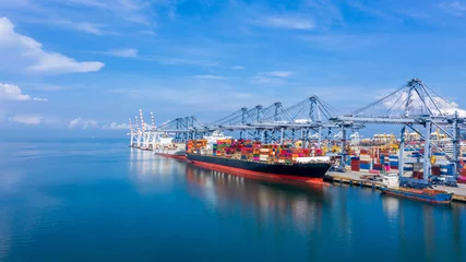 Fotobehang Container cargo ship at industial port in import export business logistic and transportation of international by container cargo ship in the open sea, © Kalyakan