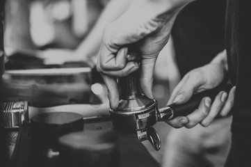 barista making coffee black and white, hands