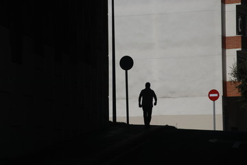 Silhouette of a man walking in the street