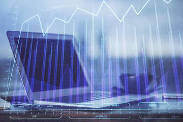 Stock market graph and table with computer background. Double exposure. Concept of financial analysis.