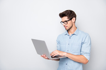 Photo of thoughtful focused clever interested freelancer holding laptop with hands wearing...