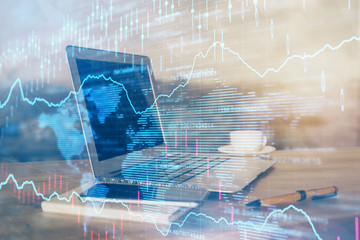 Forex market chart hologram and personal computer background. Double exposure. Concept of investment.