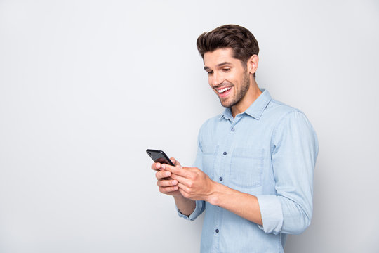 New followers in blog. Turned photo of amazed excited man blogger at copyspace using his smartphone get notification about like scream wow wear trendy outfit isolated over grey color background