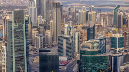 Panoramic aerial view of business bay towers in Dubai at evening timelapse.